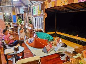 a group of children sitting on the floor of a room at Tantai Eco Farm Stay At Khao Yai in Ban Sap Noi