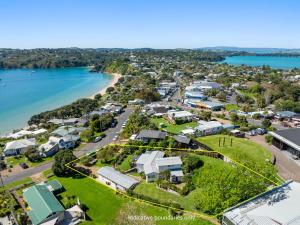 an aerial view of a town next to a body of water at Oneroa Bay View Apartment in Oneroa