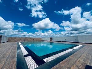 a swimming pool on the roof of a building at Transit suites by Habitat in Cochin