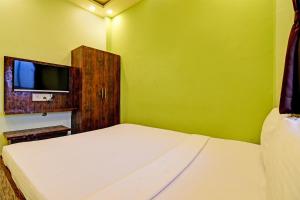 Postel nebo postele na pokoji v ubytování Super Hotel O The Orchid Residency