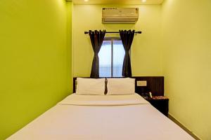 Postel nebo postele na pokoji v ubytování Super Hotel O The Orchid Residency