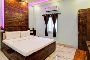 Postel nebo postele na pokoji v ubytování Super Hotel O The Orchid Residency