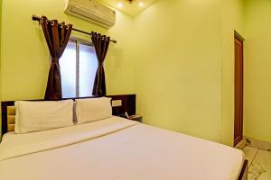 Postel nebo postele na pokoji v ubytování Super Hotel O The Orchid Residency