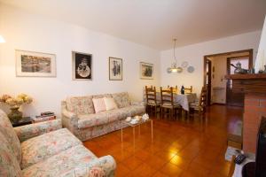 a living room with a couch and a table at Menaggio Poggio Fiorito Loggetta in Menaggio