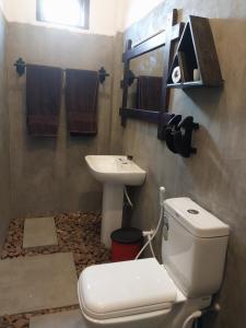 a bathroom with a toilet and a sink at Ridge Boundary View in Dambulla