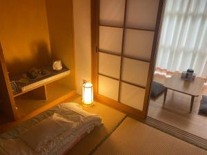 Rúm í herbergi á 山茶小屋 Yamachagoya