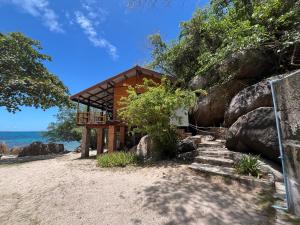 a small building on the beach with some rocks at Tao Thong Villa 1 in Ko Tao