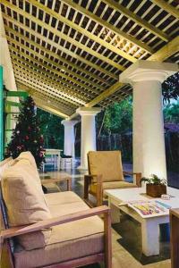 a living room with chairs and a christmas tree at Mawella House 1807, Tangalle in Tangalle