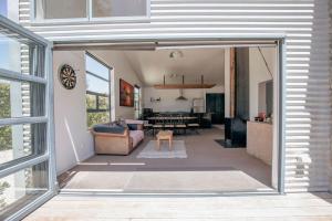 a living room with a couch and a table at Casa Del Caird in Methven