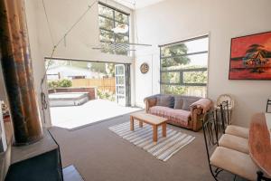 a living room with a couch and a table at Casa Del Caird in Methven