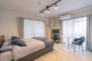 Ένα ή περισσότερα κρεβάτια σε δωμάτιο στο unito residence KYOTO Takasegawa