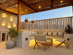 a patio with two chairs and a couch at Anara Chalet in Fins