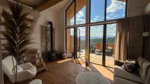 a living room with a large window and a couch at Nebo Shale in Yablunytsya