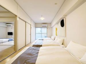 Ένα ή περισσότερα κρεβάτια σε δωμάτιο στο Dai3kuboi by b hotel - 2 Bedroom Apt for 9 ppl near PeacePark