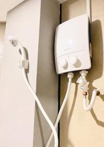 a white power cord hooked up to a wall at Hi-Inn in Miri