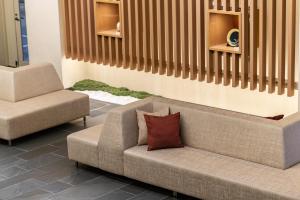 a living room with a couch and a chair at Hotel Vista Kanazawa in Kanazawa