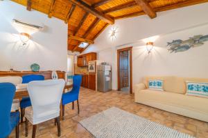 a kitchen and living room with a table and a couch at PV9 by DomusAway in Olbia