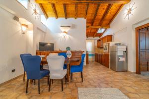 a kitchen and dining room with a table and chairs at PV9 by DomusAway in Olbia