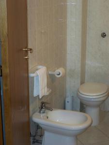 a bathroom with a toilet and a sink at Zefiro Residence in Siderno Marina