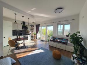 a large living room with a table and a kitchen at Apartma Tomažič in Hrušica