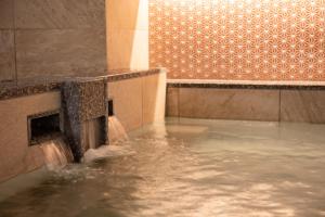 a pool of water in a fountain in a building at Hotel Vista Kanazawa in Kanazawa