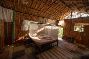 a small room with a bed in a tent at Khaama Kethna Eco Sustainable Village in Agonda