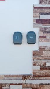 two clocks on the side of a brick building at New modern apartment, Scandinavian style, ocean view, huge terrace in Icod de los Vinos