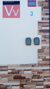 two monitors sitting on top of a brick wall at New modern apartment, Scandinavian style, ocean view, huge terrace in Icod de los Vinos