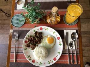 a plate of food with eggs on a table at 1775 Adriatico Suites in Manila