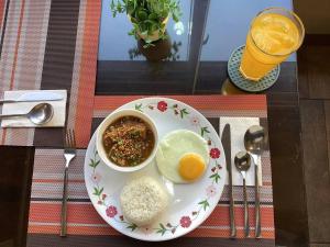 a plate of food with rice and a bowl of food at 1775 Adriatico Suites in Manila