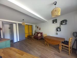 a living room with a table and a couch at La terrasse du Clermontais in Clermont-lʼHérault