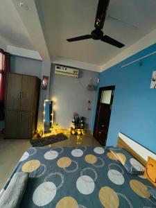 a bedroom with a large bed with a ceiling fan at Urban loft cozy 1bhk Homestay in Guwahati