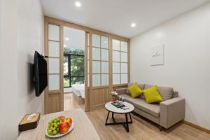 a living room with a couch and a table at 22Housing Condo 8 Nguyen Van Ngoc in Hanoi