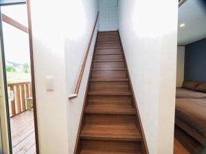 a staircase in a house with wooden floors at Retreat Furano A in Furano