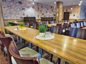 a row of tables in a room with chairs at Olympland Hotel in Trutnov +25 photos