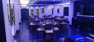 a restaurant with tables and chairs in a room at XCELSIOR HOTEL AND SPA by ROH in Shillong