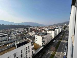a view of a city with buildings and a street at Plein centre-ville T2 refait à neuf in Aix-les-Bains
