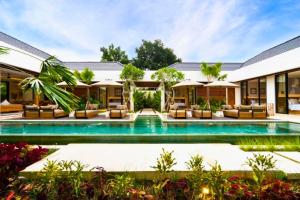 an exterior view of a villa with a swimming pool at Madaharsa 4 BR Private Pool Villa ZN203 in Ubud