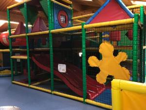 a play room with a play structure with a toy at Ty Haf in Swansea