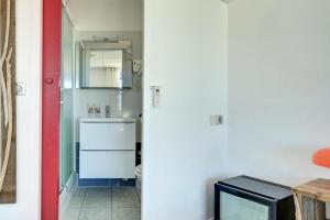 a kitchen with a sink and a white refrigerator at Hotel Camille in Saintes-Maries-de-la-Mer
