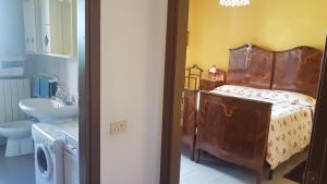 a bathroom with a bed and a sink in a room at Zarina in Pallanza