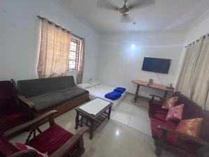 A television and/or entertainment centre at Kyle Calangute 1 bhk luxury apartment with pool