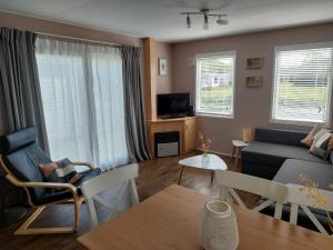 a living room with a couch and a table at Eldorado aan Zee in Petten
