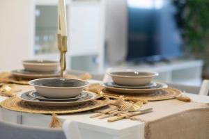 a table with three bowls and plates on a table at Espacio2,1a línea,jacuzzi,piscina in Cullera