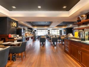 a restaurant with a bar and tables and chairs at U232 Hotel in Barcelona
