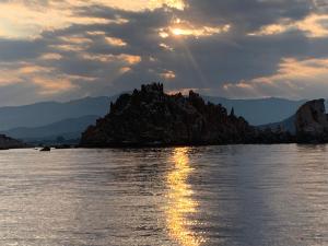 a rocky island in the middle of a body of water at Casa Vittorio in Bari Sardo