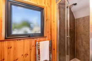 a bathroom with a window and a shower at The Kellbank in Gosforth