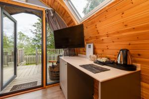 a kitchen with a large window in a wooden cabin at The Kellbank in Gosforth