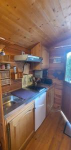 a kitchen with a sink and a stove at Aurel inattendu in Aurel