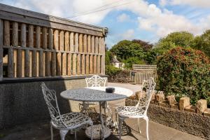 a table and chairs sitting on a patio at The Kellbank in Gosforth